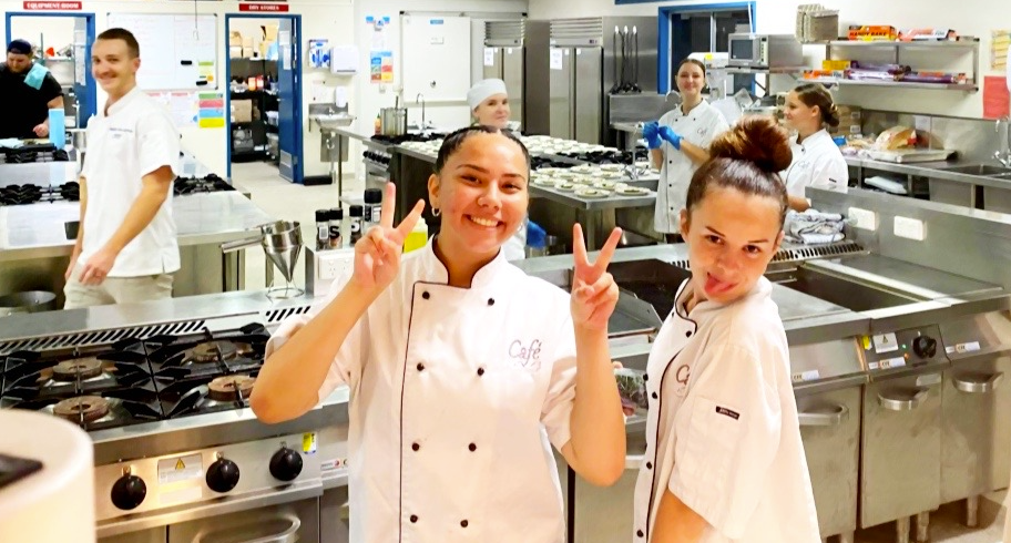 Hospitality students in chef uniform posing for pictures