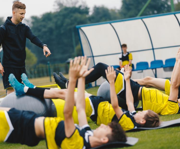 Sports team with coach doing training