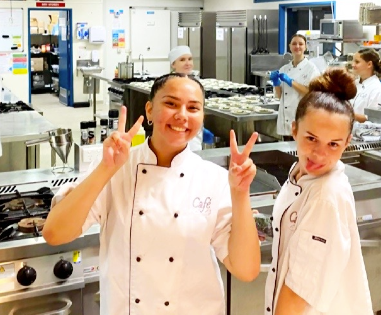 Hospitality students in chef uniform posing for pictures